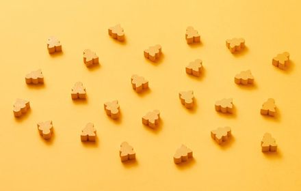 Small game pieces arranged on an orange background